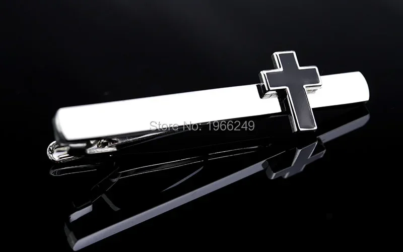 Coordinated set display: tie clip on tie at side angle, cufflinks on shirt cuff front view, both pieces visible together