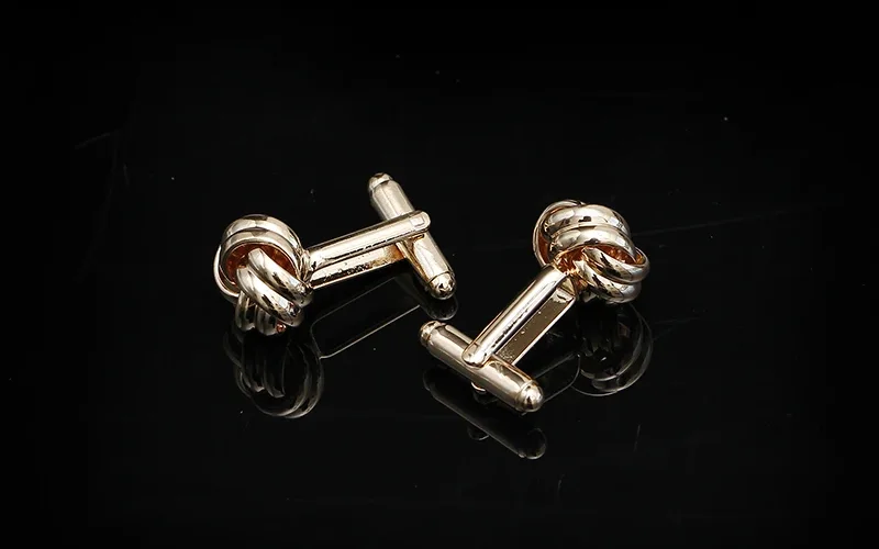 Detailed view of interwoven knot design with mirror finish on black reflective surface