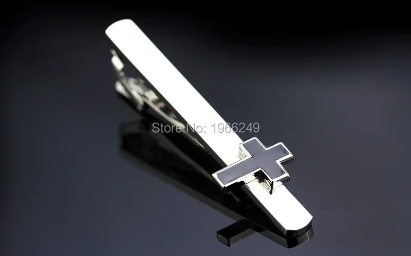 Flat-lay of the cufflink next to a dress shirt cuff and a leather watch strap, demonstrating how the two-tone finish matches both gold and silver accessories